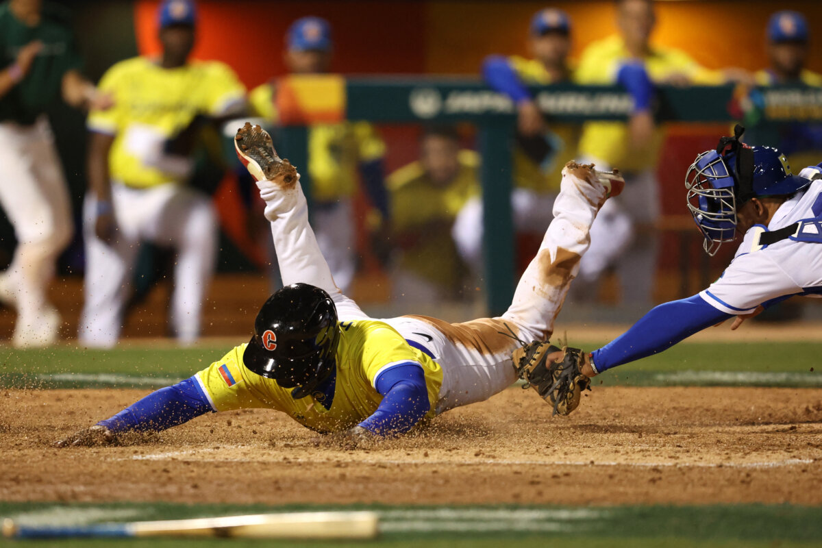 Dilson Herrera de Colombia se desliza con seguridad en el plato para anotar en una carrera más ante Brasil, en el pasado juego de béisbol.